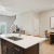 kitchen and living area with an island and bright, natural lighting