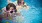 two girls in floaters, play in the pool